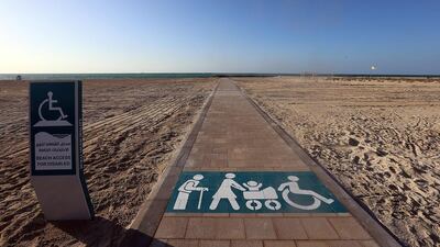 Above, the new wheelchair acessible path at the kite beach in Dubai. A solar-powered mobility kit would cost about Dh1,345, says a research from Bangladesh. Satish Kumar / The National