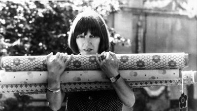 Quant with rolls of fabric in 1974. AP