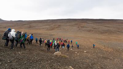 Hikers at the start of their two-hour long ascent to install the plaque commemorating the loss of Iceland's Okjokull glacier to climate change, in Borgarfjordur, Iceland. EPA