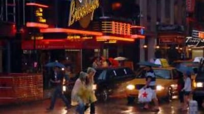 Battening down the hatches: pedestrians in New York are inundated with rain from tropical storm Hanna and a gloomy economy.