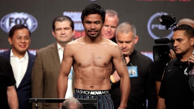Manny Pacquiao steps on the scales during the weigh-in ahead of his fight with Keith Thurman. AFP