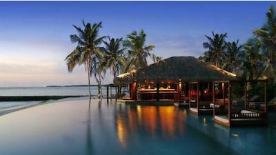 The poolside beach bar is popular at sundown. Courtesy The Residence Maldives