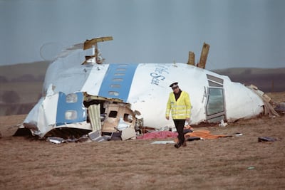 A policeman walks nearby the cockpit of the Pan Am 103 that exploded over Lockerbie on December 21, 1988. AFP