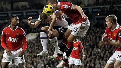 Tottenham's Michael Dawson, second from left, jumps for the ball with Manchester United's Nemanja Vidic in London yesterday.
