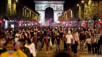 Paris Saint-Germain supporters leave the Champs-Elysees. EPA