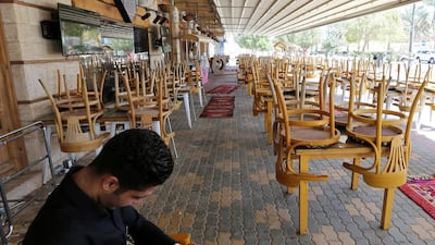 A man uses his mobile phone at an empty cafe in Riyadh, Saudi Arabia. Reuters