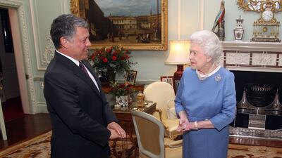 Queen Elizabeth II greets King Abdullah II of Jordan at her Buckingham Palace residence in London. Getty
