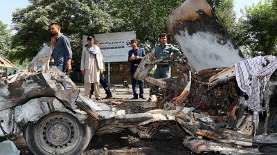 Afghans security personnel investigate at the site of a bomb explosion in front of Kanul University in Kabul on July 19, 2019. AFP