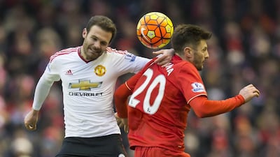 Manchester United's Juan Mata goes for a ball in the air against Liverpool in January. Jon Super / AP