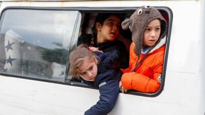 Students look out from a window of a bus in Beirut, Lebanon December 12, 2019. Reuters