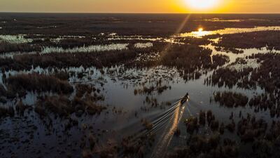 An inhabitant of the Chibayesh marshland in Iraq's southern Dhi Qar province sails home on his boat to prepare an iftar meal for his family. AFP