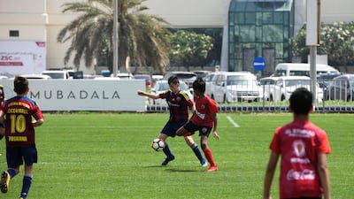 Etihad Sports Academy (plain red) vs Luceafarul from Romania (red/blue strips) under 12 age group on Day 1 of the Manchester City Abu Dhabi Cup Day at Zayed Sports City. All photos by Khushnum Bhandari for The National