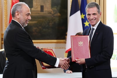 Rodolphe Saade, right, of shipping giant CMA CGM shakes hands with Asyad Group's Abdulrahman Salem Al Hatmi after signing a $500 million deal. EPA