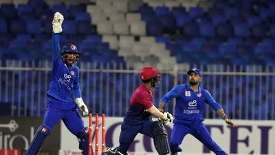 Afghanistan's Rashid Khan takes the wicket of Ethan D'Souza of the UAE.