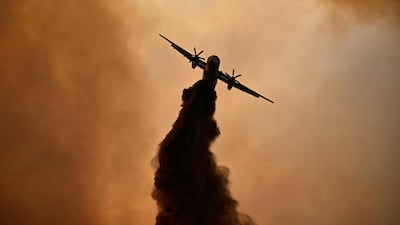 A plane drops fire retardant over a burning area near Fontjoncouse, south-western France. AFP