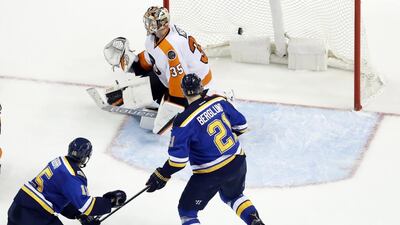 St. Louis Blues’ Robby Fabbri, bottom left, scores past Philadelphia Flyers goalie Steve Mason. Jeff Roberson / AP