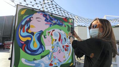 An art installation which comes to life via augmented reality with a mask on to prevent the spread of Covid-19, on October 22, 2020 in Dubai. Chris Whiteoak / The National