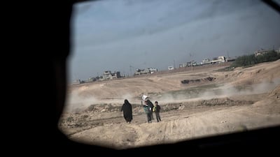 Civilians approach an Iraqi Army Ninth Armoured Division Humvee on the road to Intisar, Mosul. The city is ISIL’s last stronghold in Iraq and efforts to recapture it have met heavy resistance from the extremists who base their doctrine on Salafi jihadism. Chris McGrath / Getty Images.