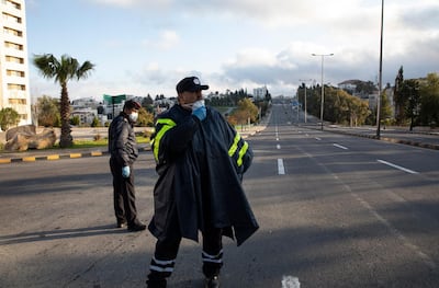 Jordanian policemen man a checkpoint in the capital, Amman, on the first day of nationwide curfew on March 21, 2020. EPA