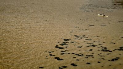 Egyptian fishermen work on their boat in the Nile River as the water appears a murky brown color due to flooding in southern provinces, in Cairo, Egypt. Nariman El-Mofty / AP Photo