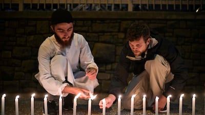 Well-wishers light 49 candles as they pay respects to victims of the attacks in Christchurch. Anthony Wallace / AFP