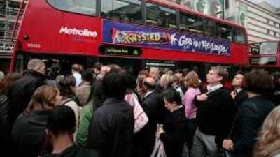 Commuters queue for buses outside Victoria Station during the strike yesterday.