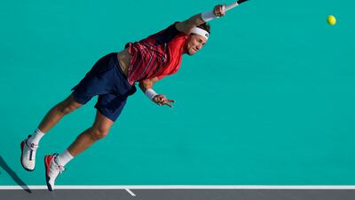 Casper Ruud serves to Carlos Alcaraz. AP