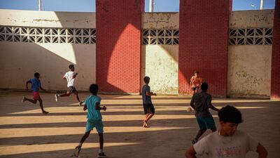 Cuban teenagers play football inside a dilapidated sports hall in Havana. AFP