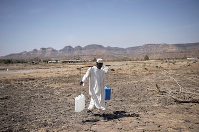 A Sudanese refugee walks back from collecting water in a refugee camp near Maganan, Ethiopia. AFP