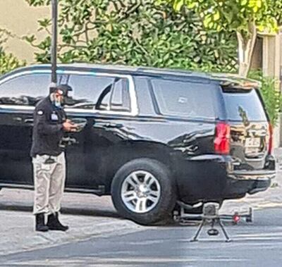 A police official prepares to launch an aerial drone to scan the Springs district, south of Dubai Marina, following reports of a big cat on the loose. Authorities urged the public to call 999 if they spot a creature that resembles a large black cat. The National
