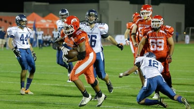 Dubai Stallions, in orange, had too much horsepower for the Dubai Barracudas and the rest of the EAFL to handle with a bruising running back in Davion Miller, above, and the league's best quarterback in Chris Wentzel to boot. Victor Besa for The National