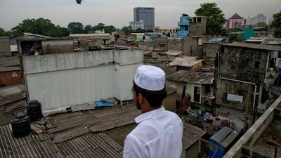 A volunteer stands in a roof of a mosque to spot possible attackers. AP Photo