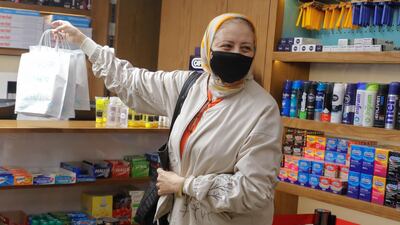 An Egyptian woman wears a protective mask in a Cairo pharmacy during the Covid-19 pandemic. Reuters