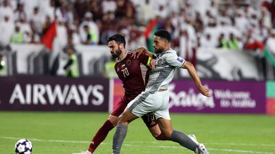 Al Wahda captain Omar Khrbin battles for the ball against Al Duhail.