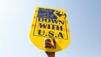 An Iranian raises an anti-US sign during a demonstration, as Iran faces renewed US sanctions. AFP