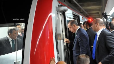 Turkish Prime Minister Recep Tayyip Erdogan (2nd from right) enters the train's cabin after President Abdullah Gul (left) at the Uskudar Marmaray station. Ozan Kose / AFP