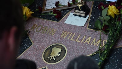 Flowers and momentos left by fans are seen at Robin Williams' star on the Hollywood Walk of Fame is seen, August 11, 2014, in Hollywood, California. AFP