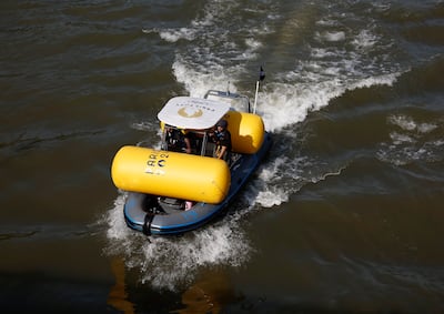 Workers remove a buoy after triathlon training was cancelled amid water quality concerns. Reuters