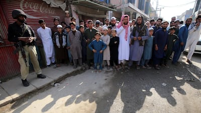 People gather at the scene of an explosion at an Islamic seminary in Peshawar, Pakistan. EPA