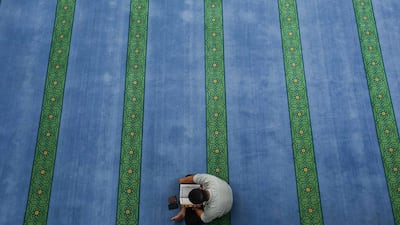 A Malaysian Muslim reads the Quran during a lunch break on the 2nd day of the holy month of Ramadan inside a mosque in Kuala Lumpur on June 30, 2014. Samsul Said/Reuters