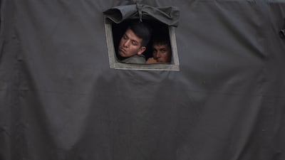 National Guards peer out of a truck parked at the entrance to the Tienditas International Bridge in Tienditas, Tachria state, Venezuela. Bloomberg