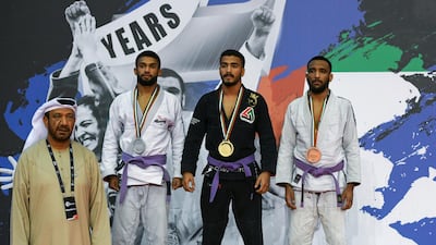 Emirati Hamad Nawad, centre, won gold in the 56kg purple belt on the final day of the Grand Slam Abu Dhabi at the Mubadala Arena in January. Khushnum Bhandari for The National