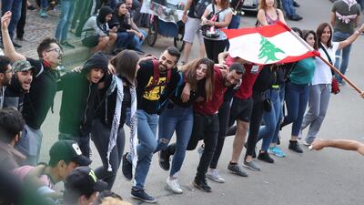 Lebanese anti-government protesters dance during a demonstration at Riad al-Solh square in the capital Beirut on the ninth day of protest against tax increases and official corruption. AFP