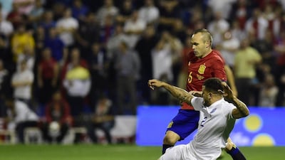 Andres Iniesta vies with defender Kyle Walker. Pierre-Philippe Marcou / AFP
