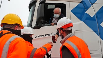A lorry driver's documents are scanned on a phone as he passes check-in for the train through the Eurotunnel in Folkstone. This is the first day after Britain's Brexit split with the European bloc's vast single market for people, goods and services. AP Photo