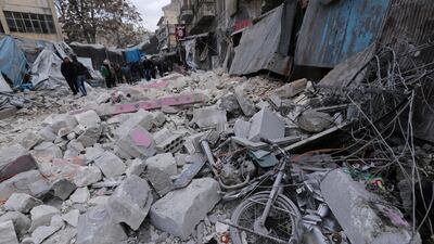 People look at destruction by the government airstrikes in the town of Ariha. AP Photo