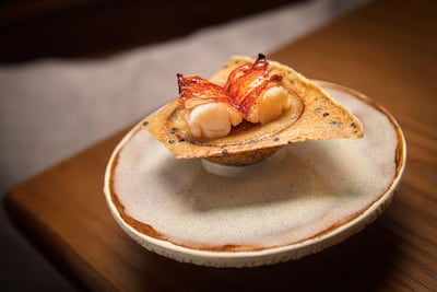 Manao's lobster khanom krok - fermented rice custard with grilled lobster tail and coriander flowers. Antonie Robertson / The National