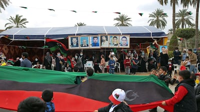 Children march past a crowd in Tripoli. AFP