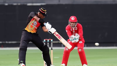 Charles Amini of Papua New Guinea hits a shot.