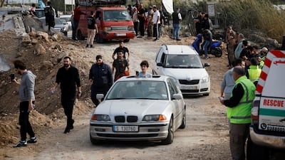 Displaced people make their way back to their homes in southern Lebanon across the Qasmiyah bridge, which was hit earlier in an Israeli air strike, after a 10-day ceasefire between Hezbollah and Israel began. Reuters